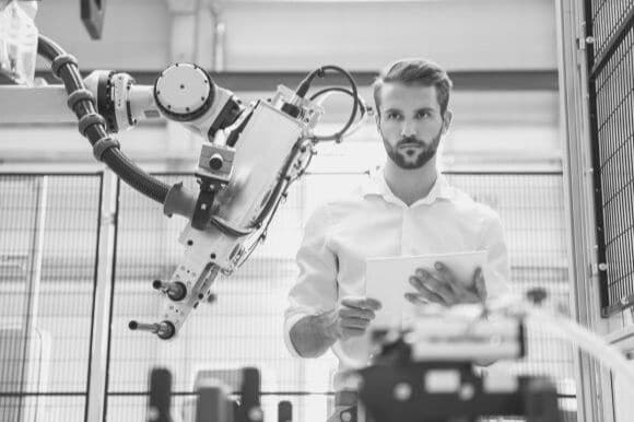 Employee using workplace automation to direct a machine at work