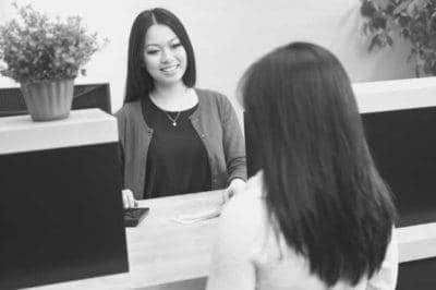 Bank teller talking to client at work